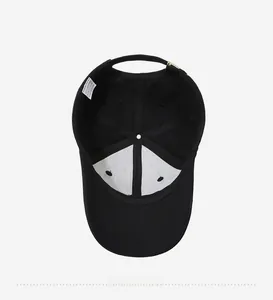 Detail view of the black cotton baseball cap interior with 100% cotton label and metal buckle