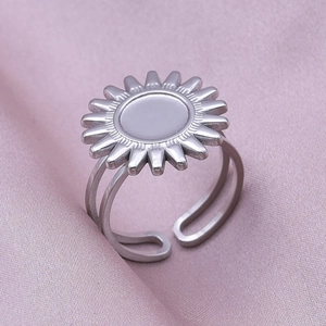 Macro detail of silver sunflower ring with geometric petals and adjustable band