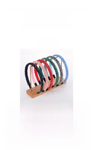 Detail view of a 2cm wide four-row crystal headband with multicolor glass drill settings