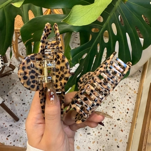 Detail of leopard print claw clips showing texture and seven-teeth secure grip design