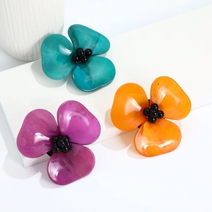 3D acrylic camellia pins in turquoise, purple, and orange with black bead centers
