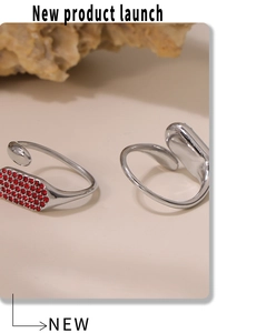 Macro de bague ajustable argentée sertie de zircons rouges sur fond de pierre