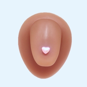 Pearlescent pink heart-shaped nail charm on a model nail with polished finish