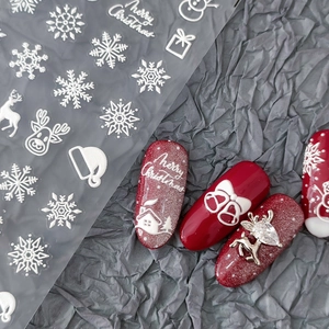 5D embossed Christmas nail art stickers featuring white snowflakes and reindeer motifs