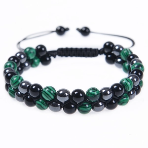Detail of hand-woven double-layer malachite and obsidian beaded bracelet with adjustable cord