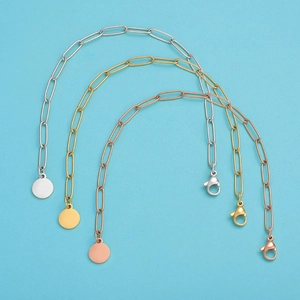 Detailed view of paperclip link bracelets in silver, gold, and rose gold finishes