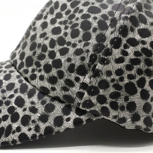 Detailed macro view of the black leopard print PU leather material and fine stitching