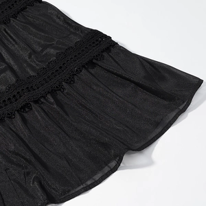 Detail of black glitter fabric dress with intricate floral mesh and lace patchwork textures