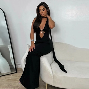 Detail of black halter maxi dress featuring a chest cutout and metallic buckle accent
