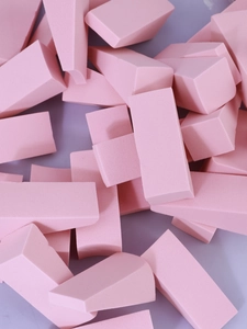 Macro shot of assorted pink non-latex triangle and rectangular makeup sponges