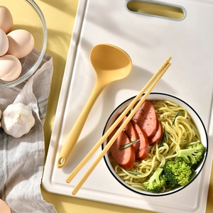 Yellow heat resistant silicone soup spoon and chopsticks set with a matte finish
