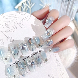 Blue Christmas snowflake press-on nails with sparkling rhinestones and pearl chains