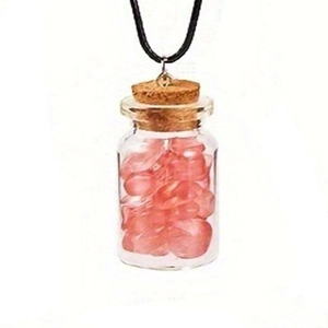 Detail of clear glass bottle pendant with pink hearts and black wax cord necklace