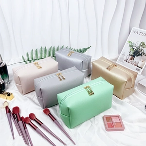 Set of five colorful PU leather makeup bags with gold zippers and pearl initial details
