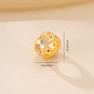 Detailed macro view showing a 0.7cm gold star bead with zircon stones and dimensions