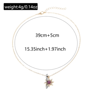 Detail view of golden sun pendant necklace showing 1.8cm diameter and 39cm chain length