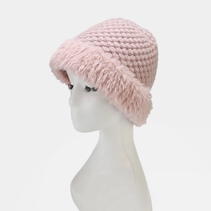 Detail of pink knitted winter hat featuring thick yarn and soft faux fur brim on mannequin