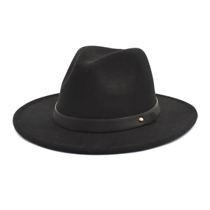 Detail of black wool fedora featuring a leather band and gold circular rivet accent