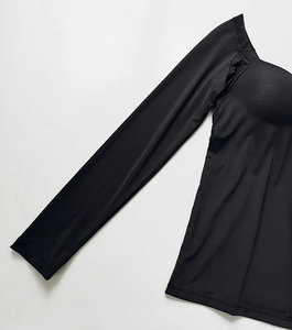 Detail of sleeve cuffs and smooth elastic fabric on black long sleeve padded bra top