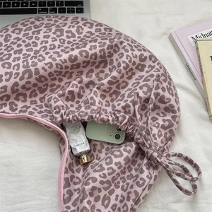 Detailed internal view of leopard print suede shoulder bag showing large storage capacity