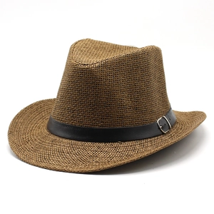 Detailed view of brown straw cowboy hat with black leather band and silver metal buckle