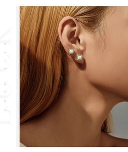 Close-up of vintage S925 silver opal studs with pavé diamonds on a model's ear