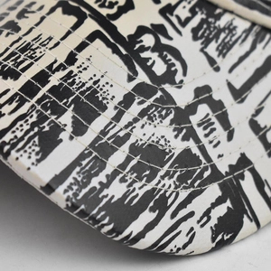 Detailed macro view of black brush calligraphy print on reinforced cotton canvas cap brim