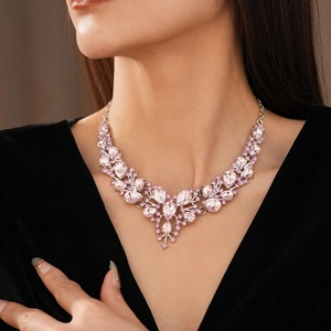 Detail of vintage teardrop crystal necklace with pink gemstones on model