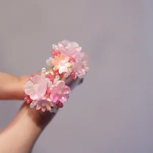 Detailed view of handmade pink resin floral earrings with pearlescent petal textures
