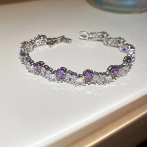 Macro detail of silver geometric bracelet with sparkling purple and white zircon stones
