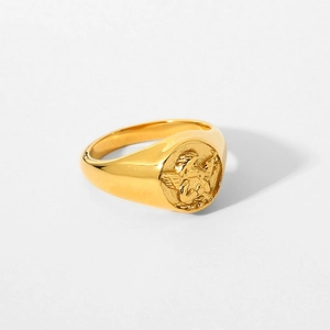 Detail shot of the vintage 18k gold plated angel relief on a round signet ring