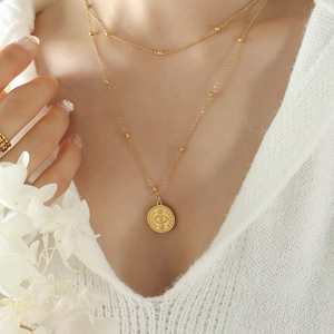 Minimalist gold-plated double-layered necklace featuring an evil eye coin pendant for women
