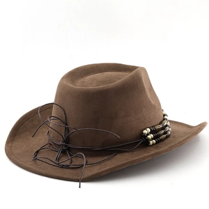 Detail of a brown western cowboy hat featuring vintage beads and leather strap decoration