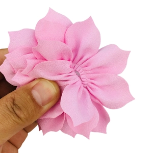 Close-up of 8cm layered pink fabric lotus flower accessory held to show scale and texture