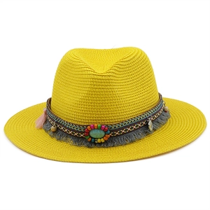 Detail of yellow woven straw hat featuring colorful beads, turquoise stone and grey tassels