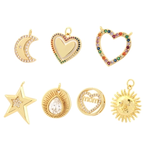 Collection of gold heart, star, moon, and sun pendants with inlaid cubic zirconia crystals