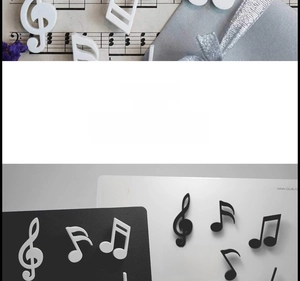 Detailed close-up of music note magnets including treble clef on a display board