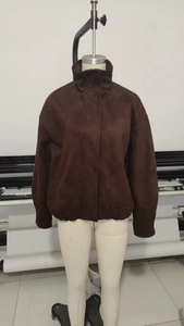 Detail of vintage brown faux suede jacket featuring a stand collar and zip closure
