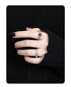 Macro detail of irregular S925 silver rings featuring a brown gemstone on hand