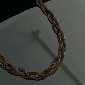 Three-strand braided necklace with two gold snake chains and one silver box chain