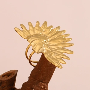 Detail view of 18K gold plated sun face open ring on a dark wooden display stand