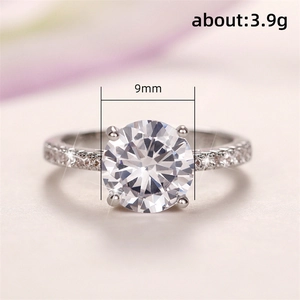 Classic silver engagement ring with 9mm round zirconia and side stones on pink background