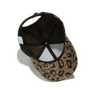 Detail of baseball cap interior showing 100% polyester mesh lining and metal buckle