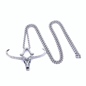 Macro detail of silver titanium steel bull skull pendant with a sturdy round link chain