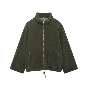 Macro texture of dark green sherpa fleece jacket with metal zipper and high collar