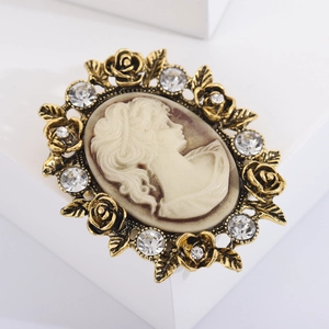 Macro shot of vintage cameo brooch with flower carvings and sparkling crystal rhinestones