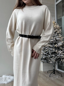 Elegant cream long sleeve knit midi dress with black belt in a cozy home setting