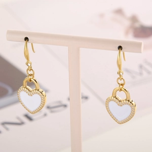 Detailed view of gold-plated white heart lock earrings with hanging chain jewelry set
