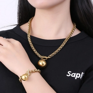 Retro hollow ball pendant necklace and bracelet set in gold-finished stainless steel