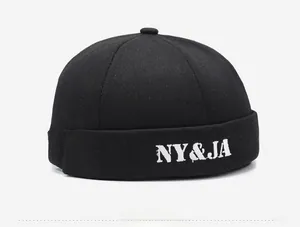 Detail of white NY&JA letter embroidery on a black cotton canvas Miki Hat docker cap